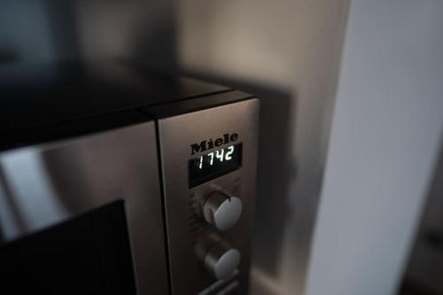 a microwave oven with the words music on it at Blue Calm Luxury Villa in Sifnos in Artemonas