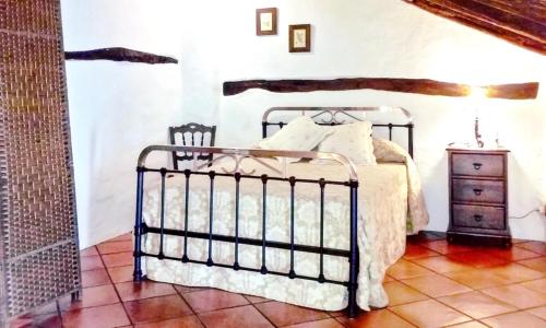 a bedroom with a bed and a dresser at Charming House in Añora with Garden in Anora