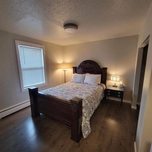 a bedroom with a large bed and a window at Nightshade BnB in Anchorage