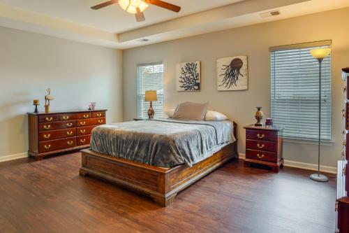 a bedroom with a bed and two dressers and a window at Johns Island Vacation Rental 11 Mi to Charleston! in Johns Island