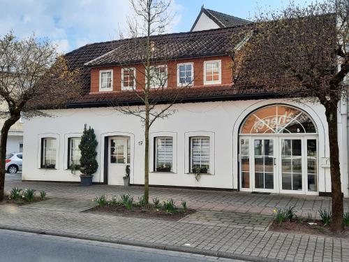 a white building with a brown roof at Wohnung in Bad Lippspringe in Bad Lippspringe