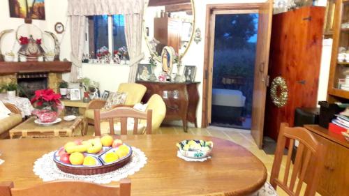 a room with a table with a bowl of fruit on it at Charming House in Siġġiewi + Jacuzzi in Siġġiewi