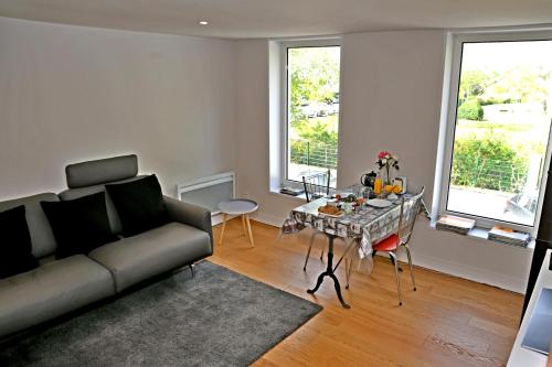 uma sala de estar com um sofá e uma mesa em Appartement d'une chambre avec wifi a Cognac em Cognac