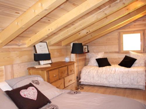 a room with two beds in a log cabin at Appartement de 5 chambres avec jardin et wifi a Hauteluce a 2 km des pistes in Hauteluce