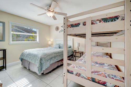 a bedroom with two bunk beds and a ceiling fan at Marco Beach Escape in Marco Island