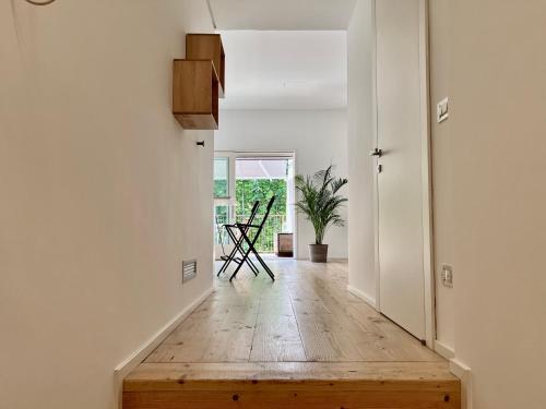 a hallway with a wooden floor and white walls at STUDIO 14 - due biciclette incluse in Treviso