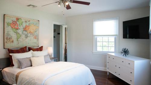 a bedroom with a white bed and a map on the wall at Casa Swinton in Delray Beach