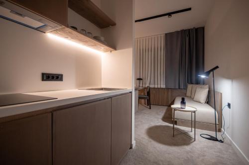 a kitchen with a bed and a table in a room at Bloom Suites in Pristina