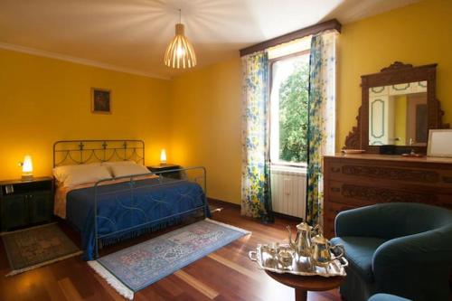 a bedroom with a blue bed and a window at 2 bedrooms house with jacuzzi enclosed garden and wifi at Decollatura in Decollatura