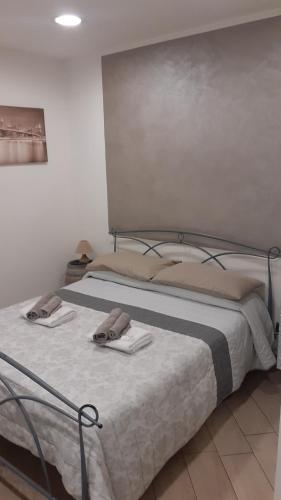a bedroom with a bed with two towels on it at Il Vicoletto in Santa Marinella