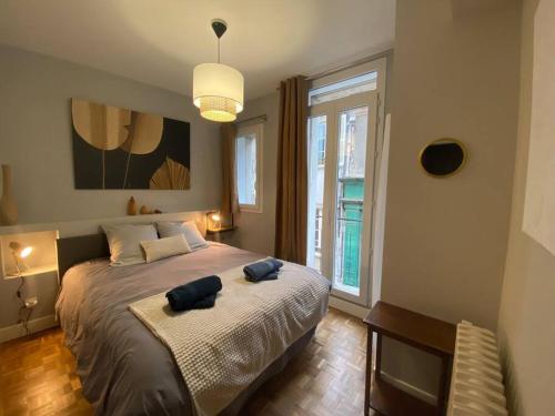 a bedroom with a bed with two pillows on it at Les Quatre Piliers - 1 min Palais Jacques Cœur in Bourges