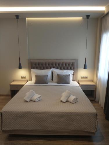 a bedroom with a large bed with two white pillows at Menta in Litochoro