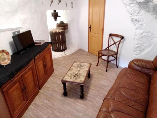 a living room with a couch and a chair at 2 bedrooms house with terrace and wifi at Arnedillo in Arnedillo