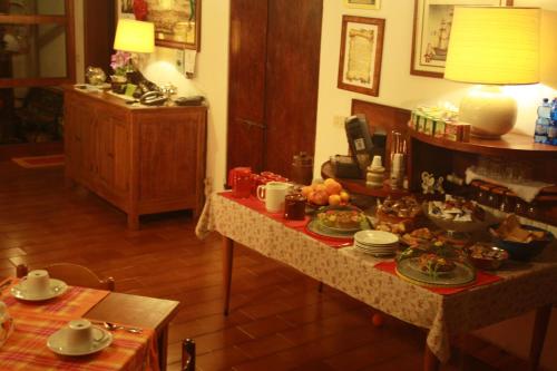 a room with a table with plates of food on it at BeB Reboglio in Rolo
