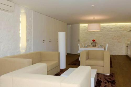 ein Wohnzimmer mit weißen Sofas und einem Tisch in der Unterkunft One bedroom house with terrace and wifi at Riba de Mouro in Riba de Mouro