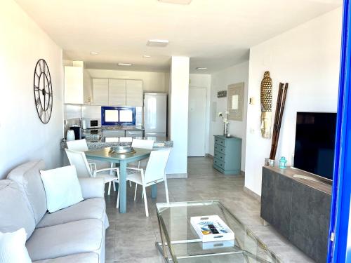 a living room and kitchen with a couch and a table at Mojacar Espectaculares Vistas al Mar in Mojácar