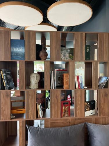 a room with a book shelf filled with books at Etnomania Boutique Hotel in Pristina