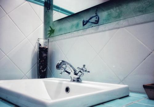 a bathroom sink with a faucet on a wall at Cal Perdigués de Boada pet friendly in Boada