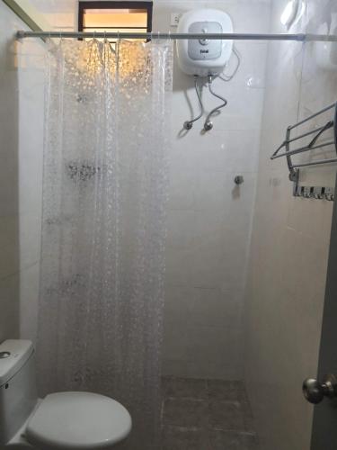 a bathroom with a shower with a toilet at Auro Maison in Puducherry