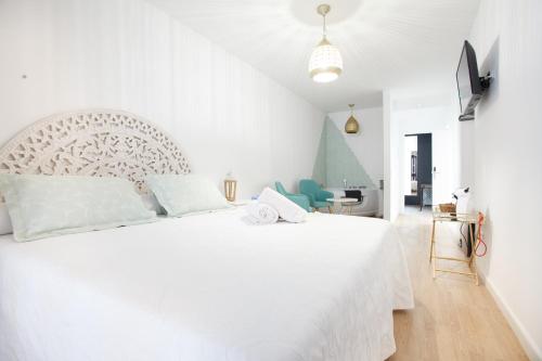 1 dormitorio blanco con 1 cama blanca grande en una habitación en Altabib Riad, en Córdoba