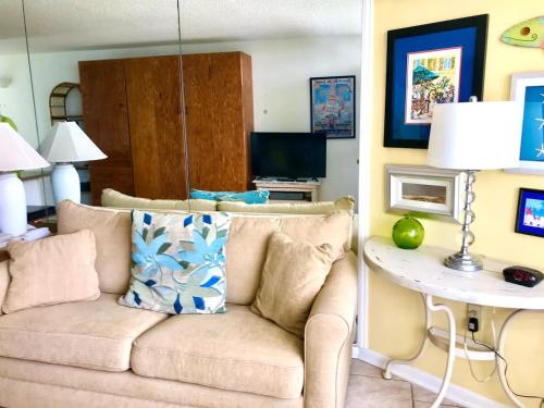a living room with a couch and a table at Sea Haven - Sea View at Symphony Beach Club in Ormond Beach