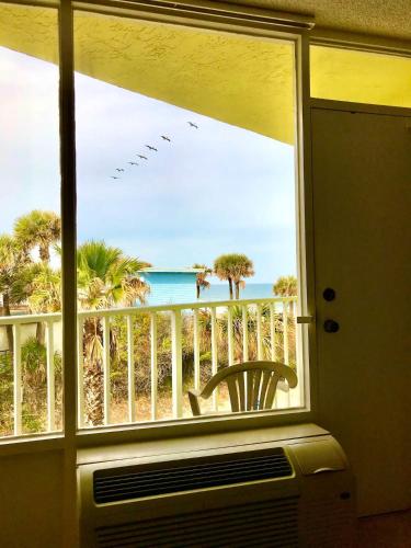 a view of the beach from a room with a window at Sea Haven - Sea View at Symphony Beach Club in Ormond Beach