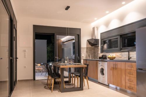 a kitchen with a table and chairs in a room at Casatino Villas in Kalianeika