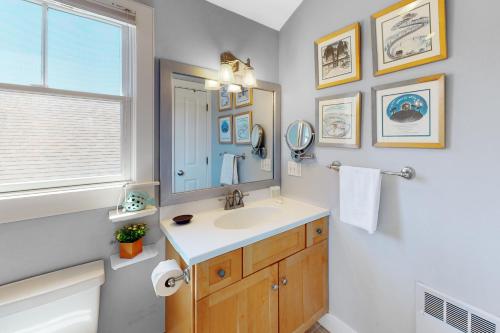 a bathroom with a sink and a mirror at Beech Tree Retreat in Provincetown