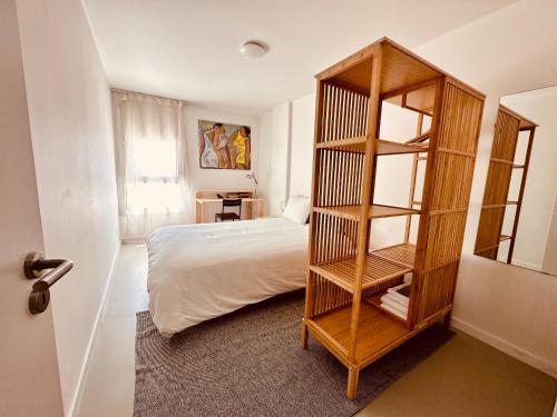 a bedroom with a bed and a book shelf at Live it up Marvila in Lisbon