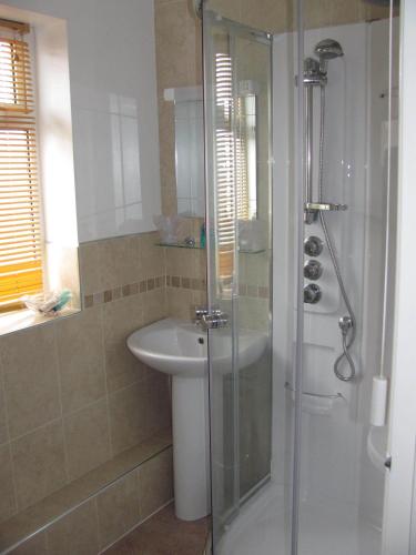 a bathroom with a shower and a sink at Philmar Guest House in Skegness