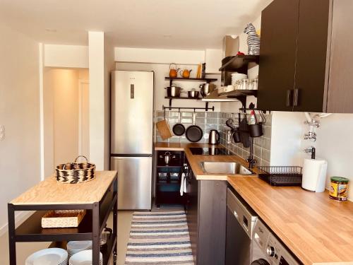 a kitchen with a sink and a refrigerator at Live it up Marvila in Lisbon