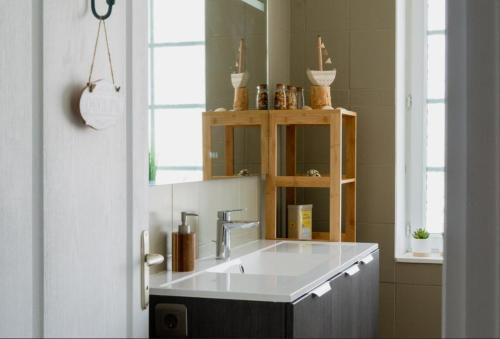 a bathroom with a sink and a mirror at Kerfloreve in Plouescat