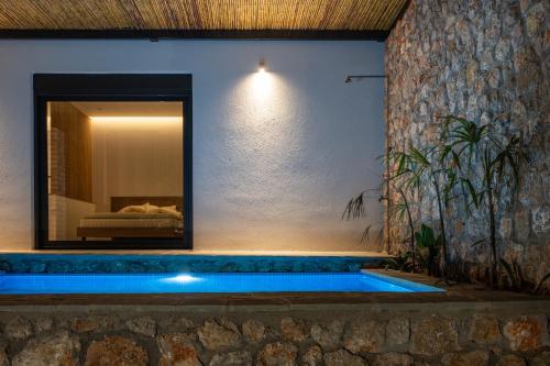 a swimming pool in a house with a mirror at Casatino Villas in Kalianeika