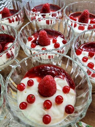 a group of glass bowls filled with raspberry desserts at Hotel Wappenhof in Braunlage