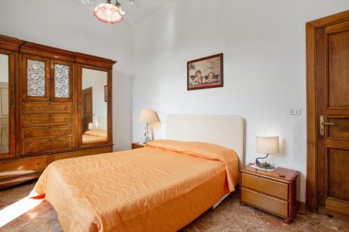 a bedroom with a bed and a dresser and a mirror at 4 bedrooms apartement with furnished terrace and wifi at Cava de' Tirreni 3 km away from the beach in Cava deʼ Tirreni