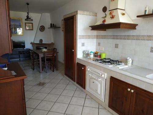 a kitchen with a sink and a stove top oven at MARGIC in San Vito lo Capo