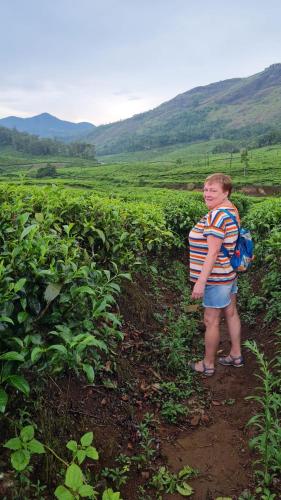 a young boy standing in a field of crops at Bella Casa in Vagamon