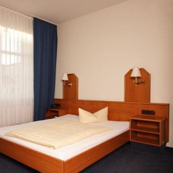 a bedroom with a large bed and a window at Akzent Hotel Residence Bautzen in Bautzen