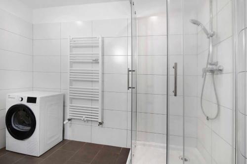 a bathroom with a washing machine and a shower at Apartment with balcony in Marl in Marl