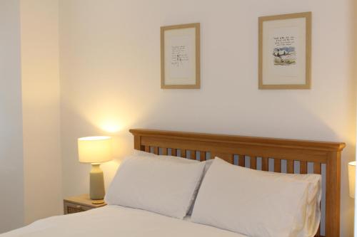 sypialnia z łóżkiem i 2 zdjęciami na ścianie w obiekcie Pike O'Blisco w mieście Bowness-on-Windermere