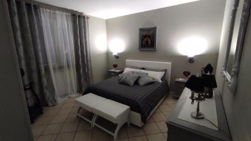 a small bedroom with a bed and a chair at Cactus house relax in Corchiano