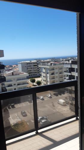 a view of a parking lot from a window at Amorosa Beach Sun And Sea in Viana do Castelo