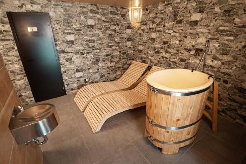 a room with a barrel and a chair and a trash can at Hotel Kras in Jedovnice