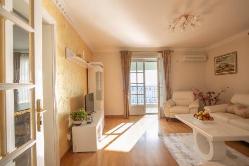 a living room with a couch and a tv at Montesan Luxury Apartment Beach Front in Sveti Stefan