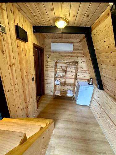 a room with a wooden cabin with a chair in it at Tanura Bungalows in Çamlıhemşin
