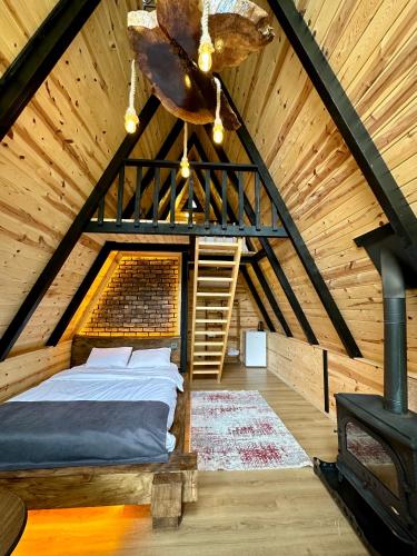 a bedroom with a bed in a attic at Tanura Bungalows in Çamlıhemşin