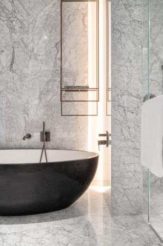 a bathroom with a bath tub and a glass shower at The Ritz-Carlton, Mexico City in Mexico City