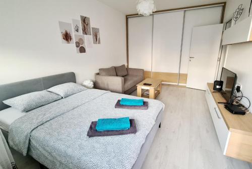 a bedroom with a large bed and a couch at ADA View apartment in Belgrade
