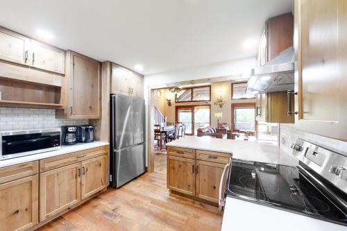 a kitchen with wooden cabinets and stainless steel appliances at Norris Lake Escape in New Tazewell