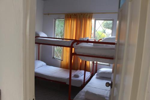 a room with three bunk beds and a window at Cabaña Campestre Casablanca in San Juan de Arama